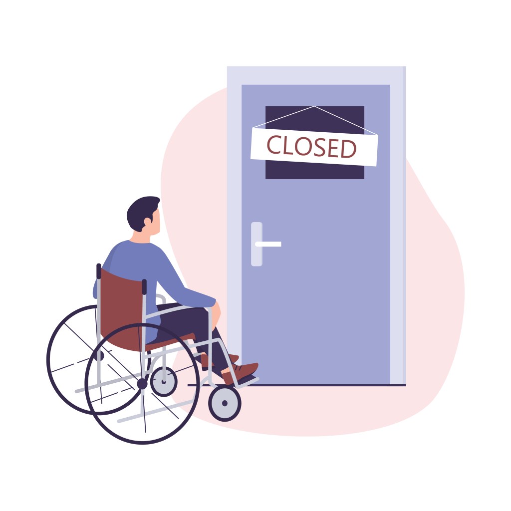 A wheelchair user approaches a bathroom door with a closed sign on it