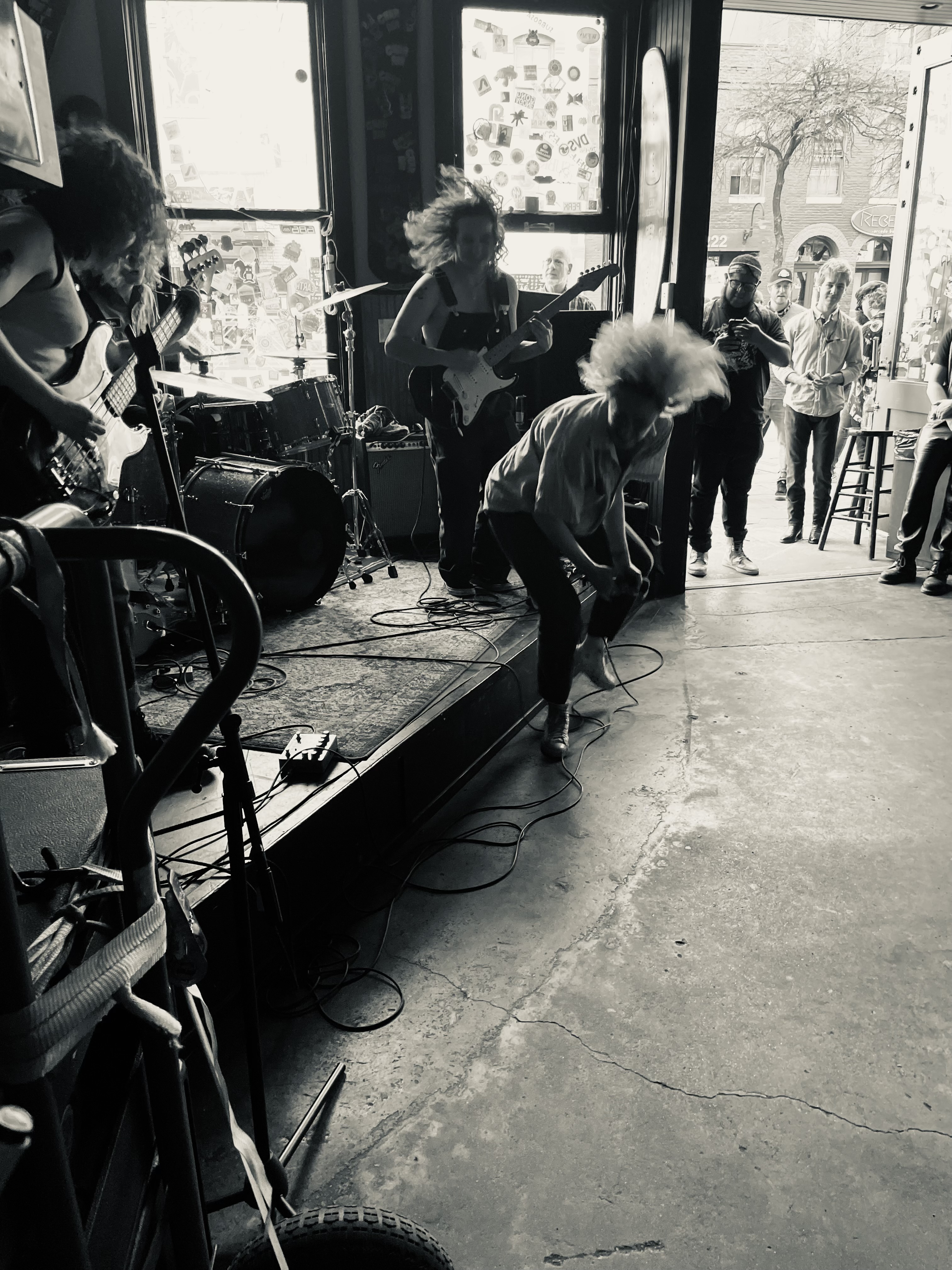 The Bobby Lees performing live on stage with the lead singer captured mid head swing with hair flying.