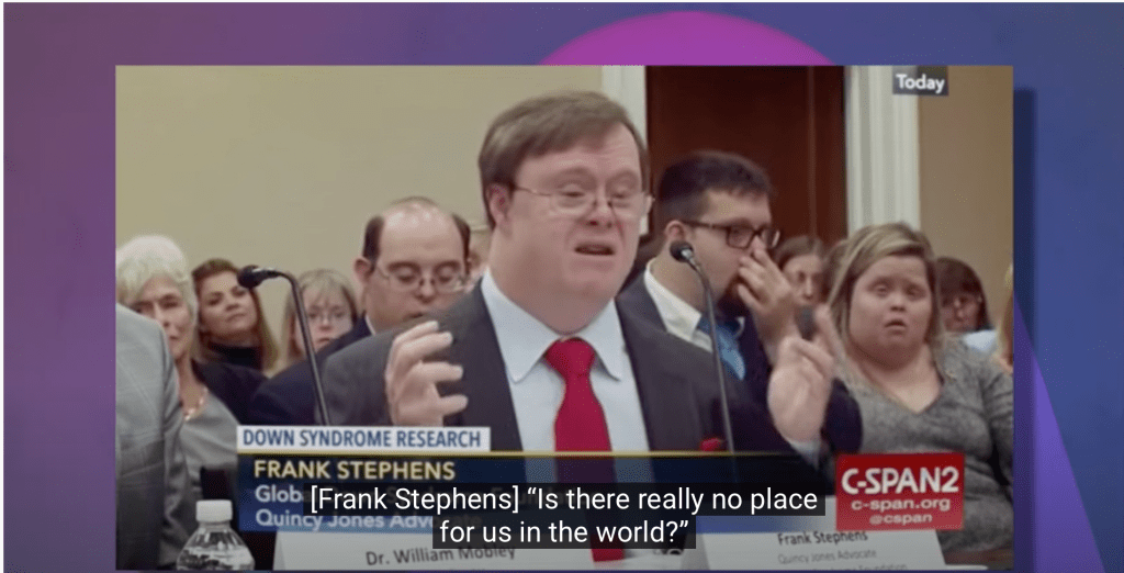 A man with Down's syndrome dressed in a suit and tie testifies before US Congress. Caption reads: Is there really no place for us in the world?