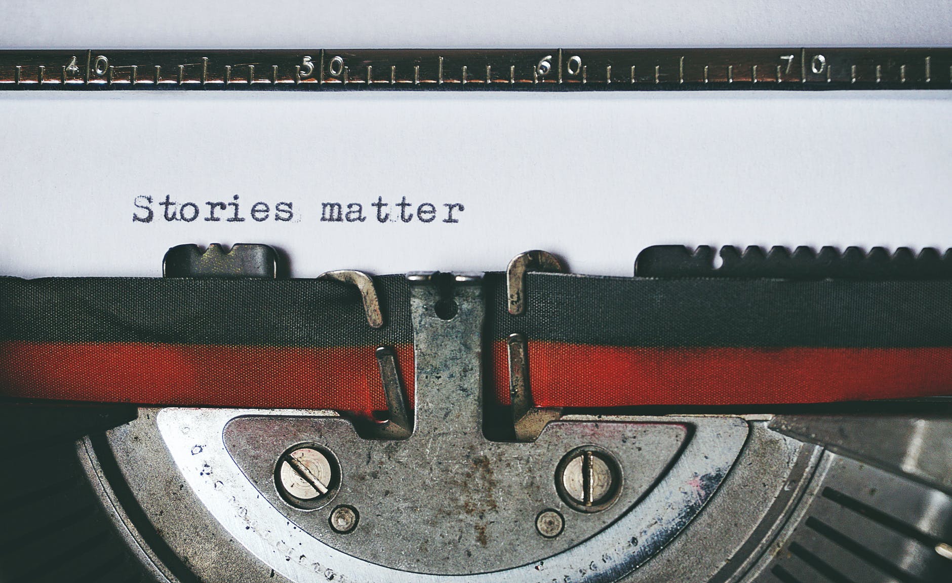 black and red typewriter with "Stories matter" typed out