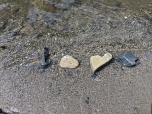 Beach pebbles arranged to spell "Love"