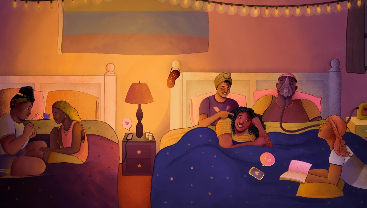 A group of disabled queer Black folks talk and laugh at a sleepover, relaxing across two large beds. Everyone is dressed in colorful t-shirts and wearing a variety of sleep scarves, bonnets, and durags. On the left, two friends sit on one bed and paint each other’s nails. On the right, four people lounge on a bed: one person braids another’s hair while the third friend wearing a C-PAP mask laughs, and the fourth person looks up from their book. In the center, a bedside lamp illuminates the room in warm light while pill bottles adorn an end table.