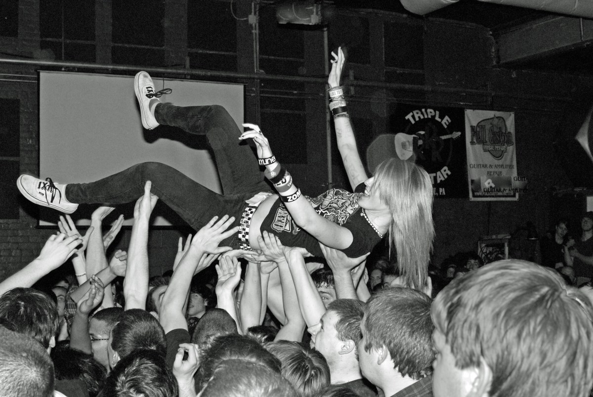 Woman crowdsurfing in a mosh pit