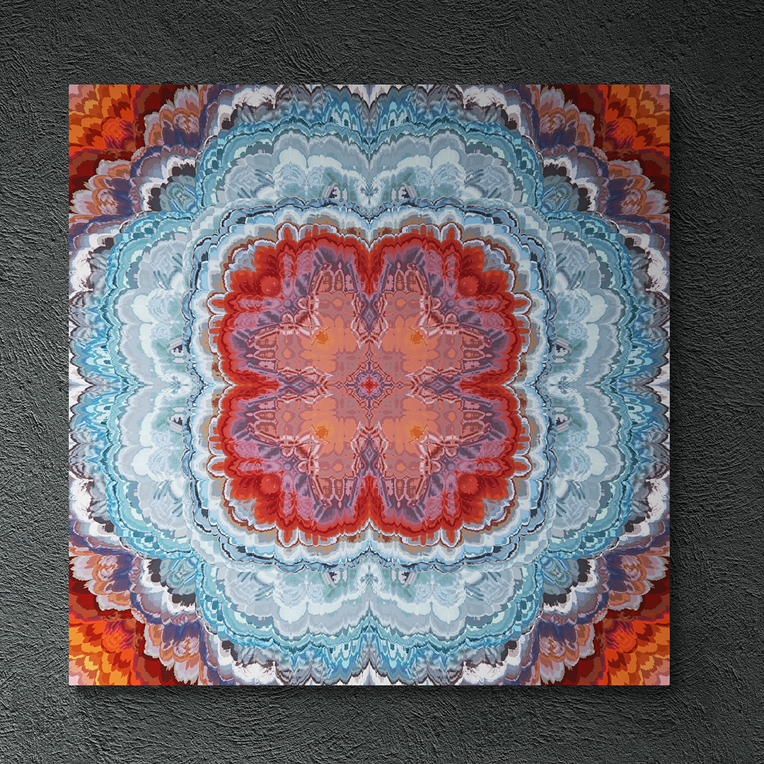A bursting kaleidoscopic geometrical form with 4 sides of symmetry pointing angularly to each of the four corners of a square shaped canvas against a dark grey textured wall. There is a small red shaped plus at the very center, surrounded by orangish-peach and periwinkle butterfly like shapes at 45 degree angles from each other aligned to the mid center going up and also to the sides. The butterfly shapes are encased in a deeper red flower like shape before a region of light blue geometric textures. Near the corners are feathered white, dark grey-purple, burgundy and orange feather like edges.